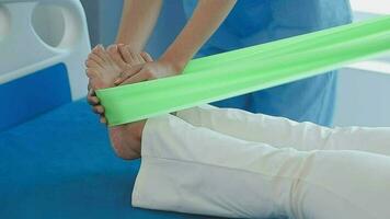 Physiotherapist working with patient in clinic, closeup video