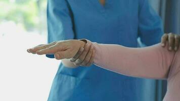 Physiotherapist working with patient in clinic, closeup video