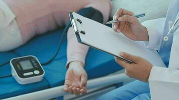 Doctor use stethoscope, checking up heart beat, lunch of auscultation in doctor office at hospital. Patient worker has to get medical checkup every year for her health or medical checkup cardiologist video