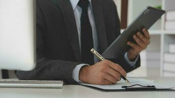 Financial analysts analyze business financial reports on a digital tablet planning investment project during a discussion at a meeting of corporate showing the results of their successful teamwork. video
