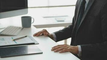 Financial analysts analyze business financial reports on a digital tablet planning investment project during a discussion at a meeting of corporate showing the results of their successful teamwork. video