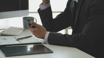 Financial analysts analyze business financial reports on a digital tablet planning investment project during a discussion at a meeting of corporate showing the results of their successful teamwork. video