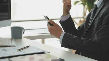 Financial analysts analyze business financial reports on a digital tablet planning investment project during a discussion at a meeting of corporate showing the results of their successful teamwork. video