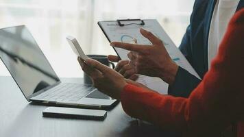 Financial analysts analyze business financial reports on a digital tablet planning investment project during a discussion at a meeting of corporate showing the results of their successful teamwork. video