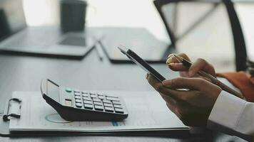 Financial analysts analyze business financial reports on a digital tablet planning investment project during a discussion at a meeting of corporate showing the results of their successful teamwork. video
