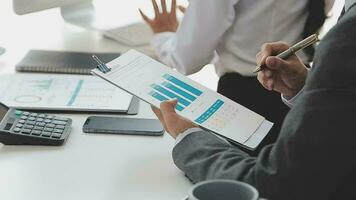 Financial analysts analyze business financial reports on a digital tablet planning investment project during a discussion at a meeting of corporate showing the results of their successful teamwork. video