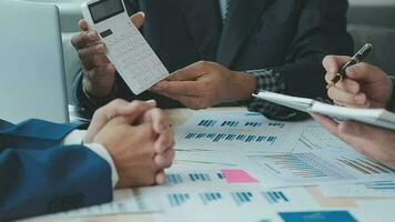 Financial analysts analyze business financial reports on a digital tablet planning investment project during a discussion at a meeting of corporate showing the results of their successful teamwork. video