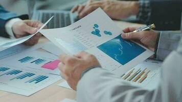 Financial analysts analyze business financial reports on a digital tablet planning investment project during a discussion at a meeting of corporate showing the results of their successful teamwork. video