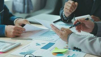 Financial analysts analyze business financial reports on a digital tablet planning investment project during a discussion at a meeting of corporate showing the results of their successful teamwork. video