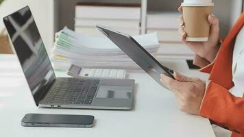 Financial analysts analyze business financial reports on a digital tablet planning investment project during a discussion at a meeting of corporate showing the results of their successful teamwork. video