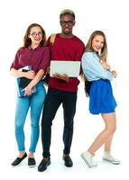 Happy students standing and smiling with books, laptop and bags isolated on white photo