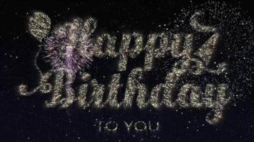 Happy birthday celebration greeting text with particles and sparks on black night sky with colored slow motion fireworks on background, beautiful typography magic design video