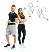 Athletic man and woman with dumbbells with the chemical formula on background - concept of healthy life photo