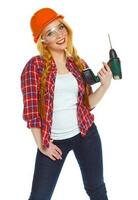 Female construction worker in a helmet with a perforator photo