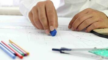 Architect in suit erasing wrong lines in project, businessman correcting mistakes on blueprint, selective focus video