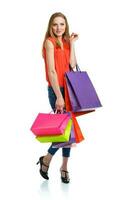 Happy caucasian woman holding shopping bags on white. Holidays concept photo