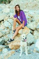 Woman with a dog on a walk on the beach photo