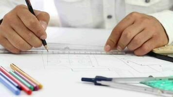 Architect hands drawing lines using ruler and pencil on paper video