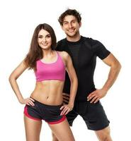 Athletic couple - man and woman after fitness exercise on white photo
