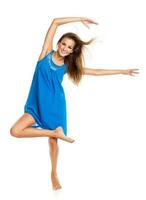Young girl dancing in a blue dress photo