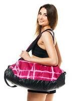 Portrait of attractive caucasian smiling woman with sports bag isolated on white photo