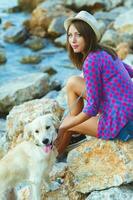 Woman with a dog on a walk on the beach photo