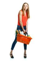 Young caucasian woman with assorted grocery products in shopping basket isolated on white photo