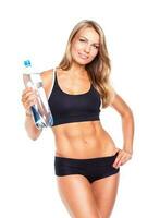 Young athletic girl with bottle of water on white photo