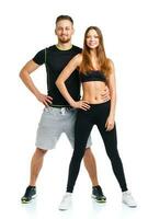 Athletic couple - man and woman after fitness exercise on the white photo