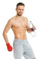 Athletic attractive man wearing boxing bandages with bottle of water on the white photo