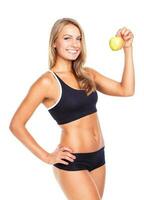 Young smiling girl holding green apple in hand photo