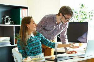 Beautiful young woman and man working from home photo