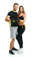 Happy athletic couple - man and woman with measuring tape on and ginger up the white photo