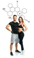 Athletic man and woman after fitness exercise with the chemical formula on background - concept of healthy life photo