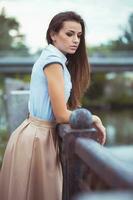 Young beautiful, elegantly dressed woman in the park or outdoor photo