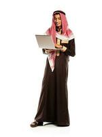 Young smiling arab with laptop isolated on white photo