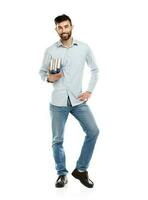 Young bearded smiling man with books in hands on white photo
