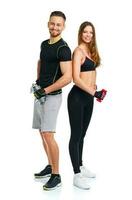 Athletic couple - man and woman with dumbbells on the white photo