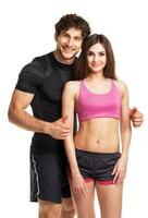 Sport couple - man and woman after fitness exercise on the white photo