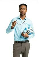 African american college student with books in his hands standing on white photo