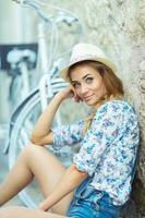 Happy woman with bicycle on street of old town photo