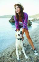 Woman with a dog on a walk on the beach photo