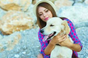 mujer con un perro en un caminar en el playa foto