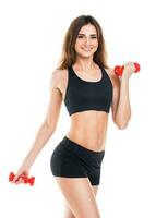 Beautiful slim woman with dumbbells, isolated on white photo