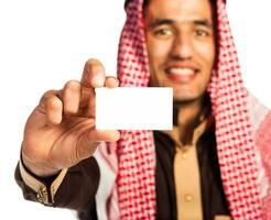 Young smiling arab showing business card in hand isolated on white photo