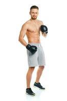 Athletic attractive man wearing boxing gloves on the white photo