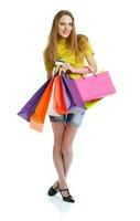 Shopaholic woman with shopping bags and credit card over white background photo