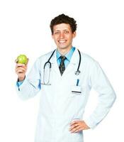 Portrait of a male smiling doctor holding green apple on white photo