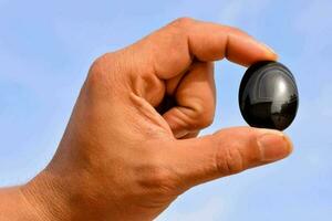 Hand holding a semi precious stone photo