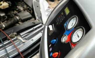 refueling of car air conditioner in garage photo